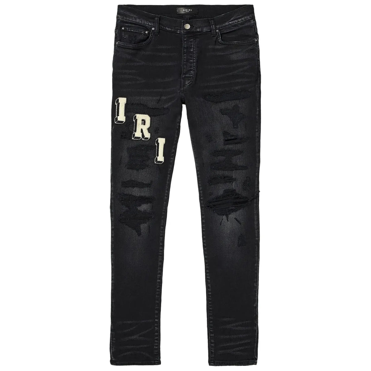 AMIRI Faded Black Varsity Jeans with distressed rips and large white "IRI" letter patches on the left thigh.
