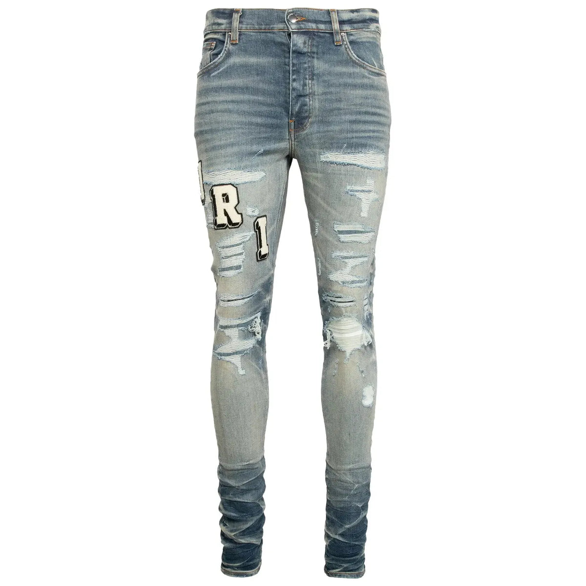AMIRI Varsity Jean, vintage indigo, heavily distressed with rips, "R" and "1" patches on left thigh, stacked ankles.