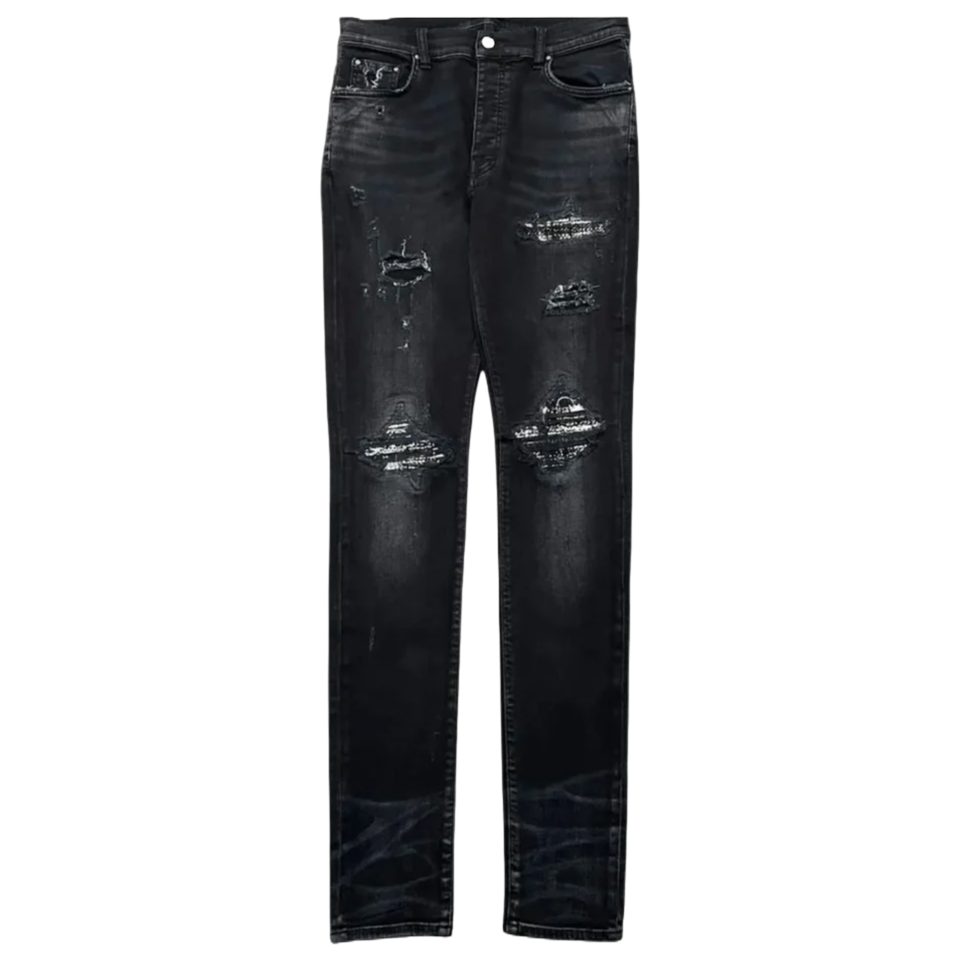 AMIRI MX1 Bouclé Jean. Aged patch black denim with distressed rips and textured silver bouclé patches on thighs and knees.