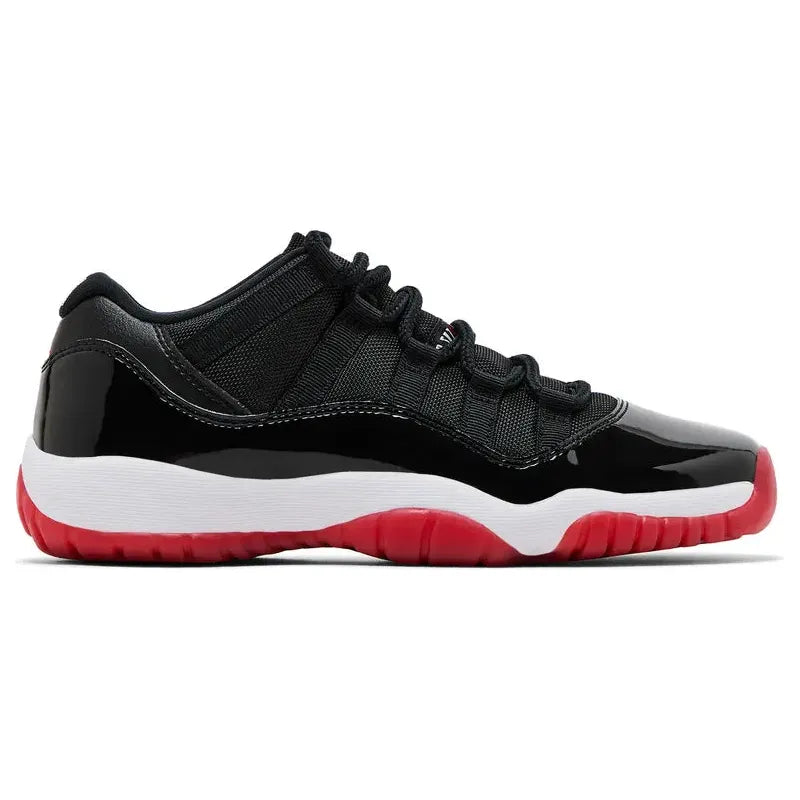 Air Jordan 11 Low Bred GS: black mesh & patent leather upper, white midsole, red rubber outsole.