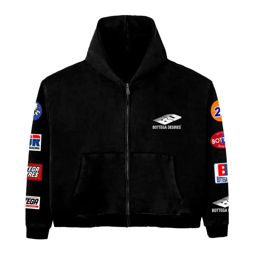Black Bottega Desires zip-up hoodie with white chest logo, front pockets, & colorful racing-style patches on sleeves.