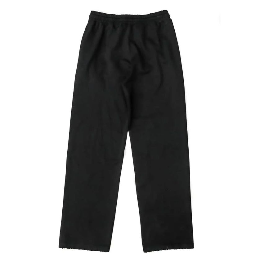 Bottega Desires black tech sweatpants, back view, with an elastic waistband and raw bottom hem.