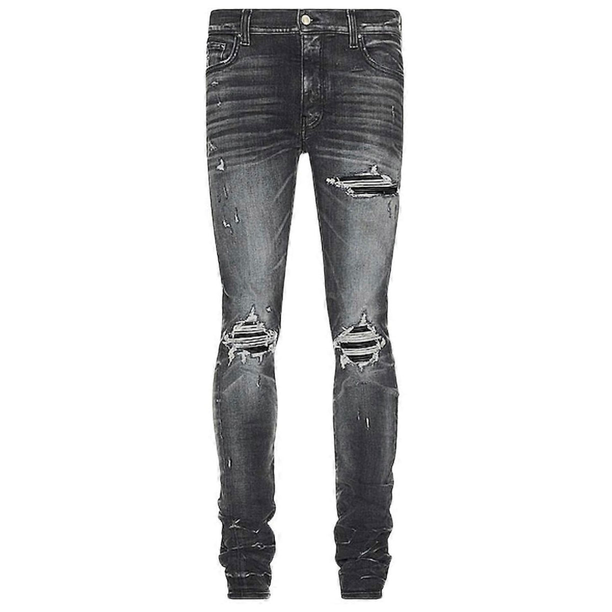 AMIRI MX1 skinny jeans in Storm Grey, heavily distressed with large rips at both knees and upper left thigh.
