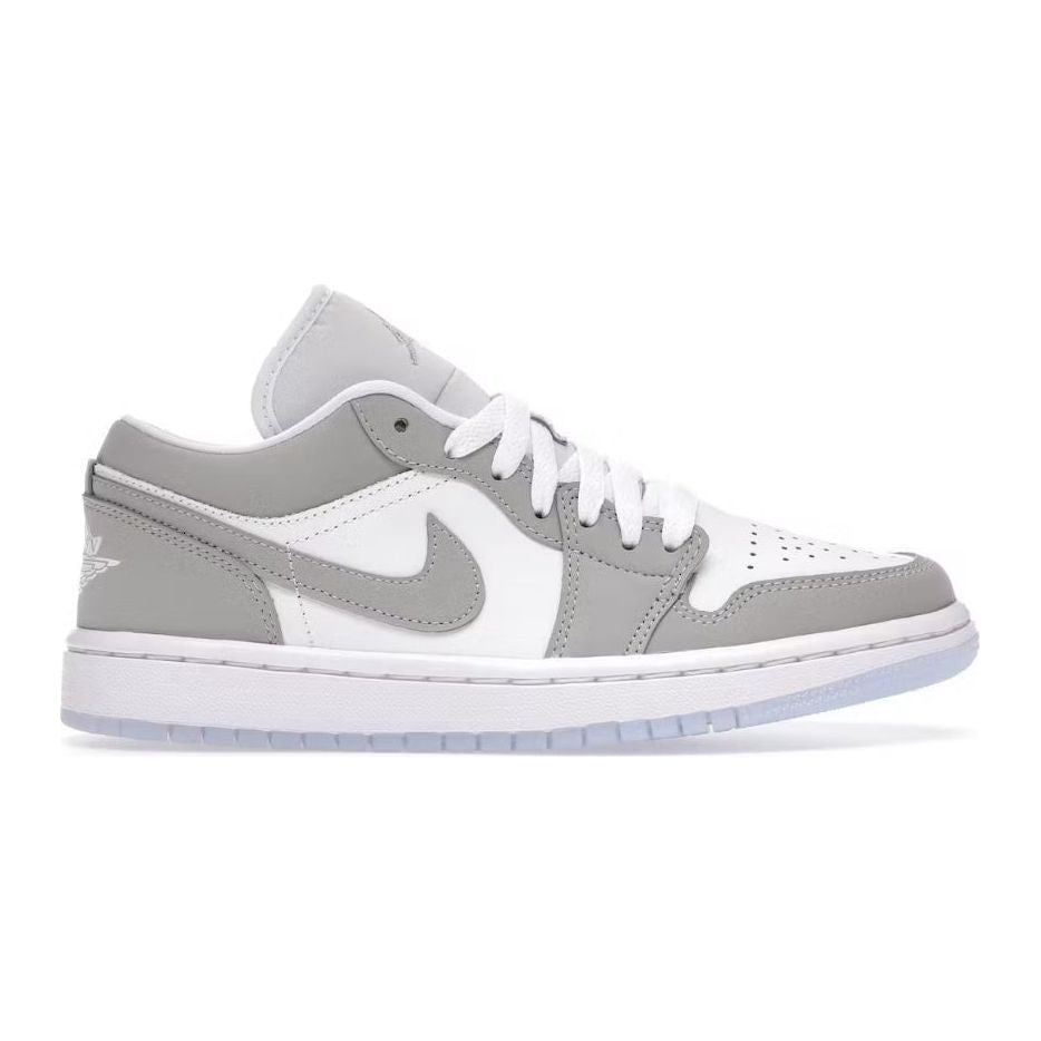 Air Jordan 1 Low Wolf Grey. White upper with grey overlays, matching Swoosh, white laces, Wings logo heel, translucent sole.