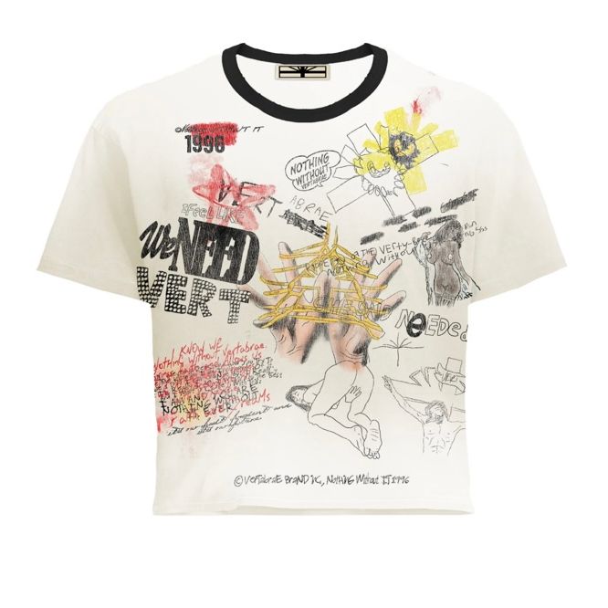 Vertabrae Detention Tee, cream, with black collar. Allover graffiti print: "WE NEED VERT", sketched figures, hands, abstract marks.