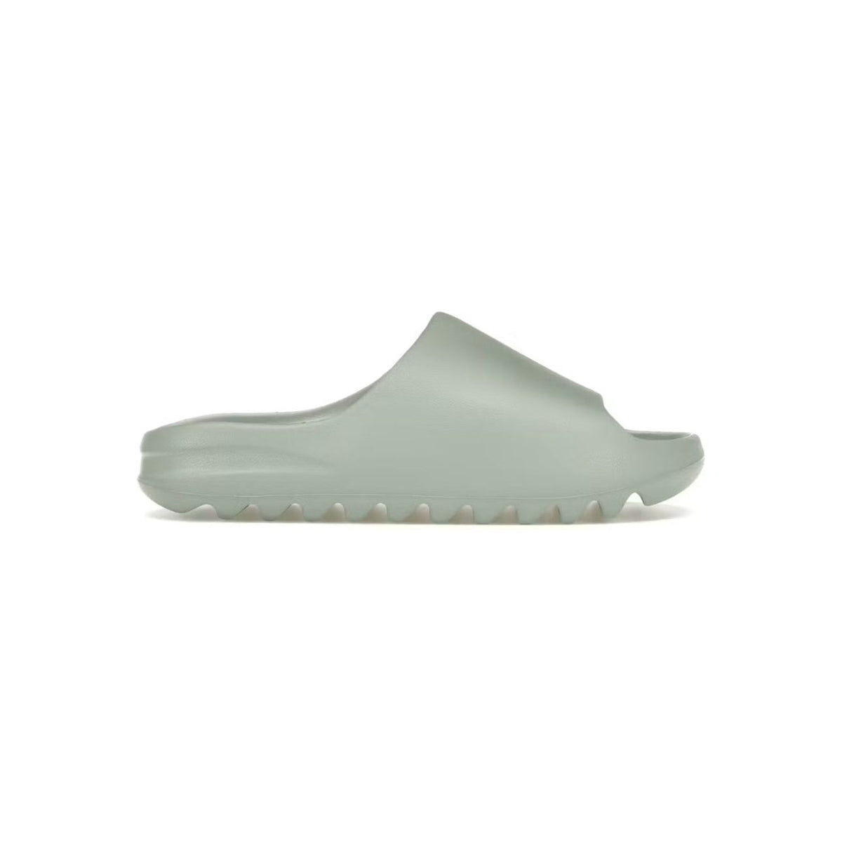 Yeezy Slide Salt in light greenish-grey, featuring a wide strap upper and thick, serrated sole.
