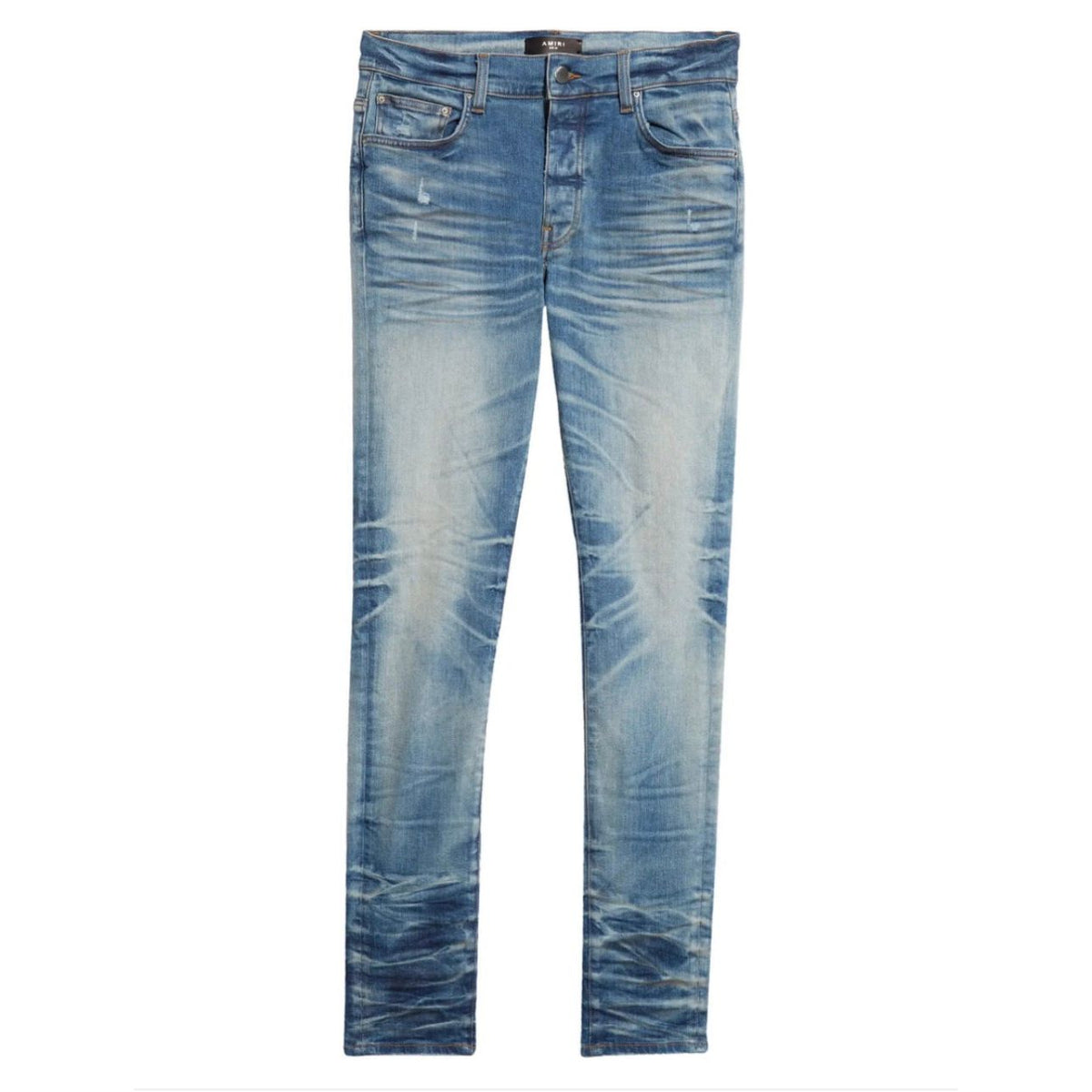 AMIRI Stack Jean in honeycomb indigo wash, faded light blue with distressed knees and heavy ankle stacking.