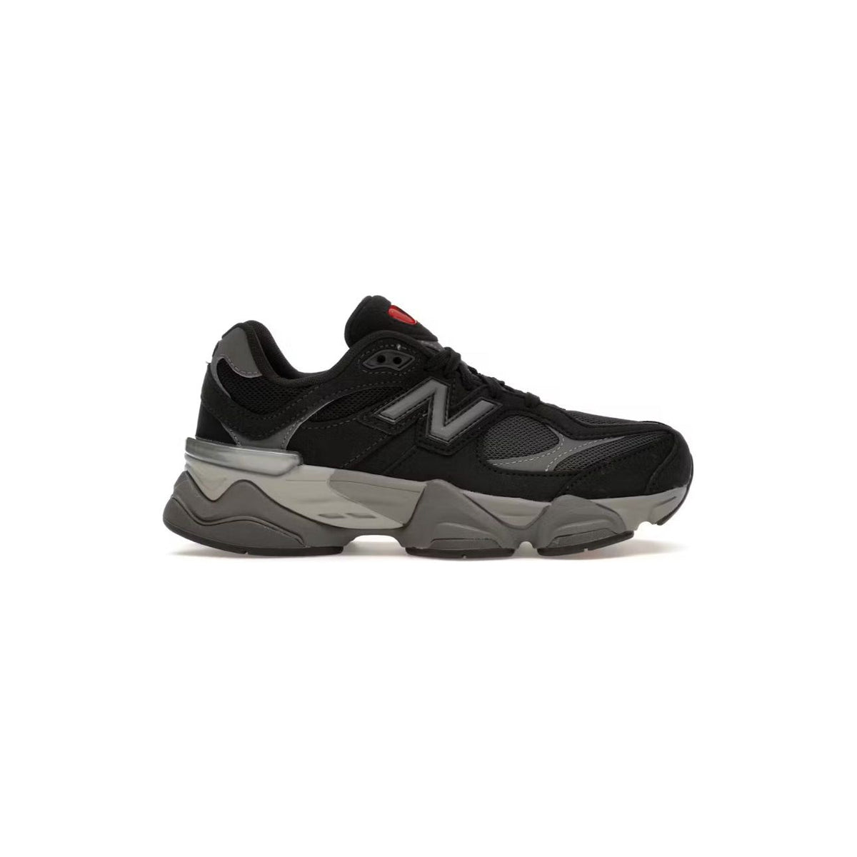 New Balance 9060 GS sneaker, black upper with grey details, large grey N logo, chunky sculpted grey midsole, and small red accent.