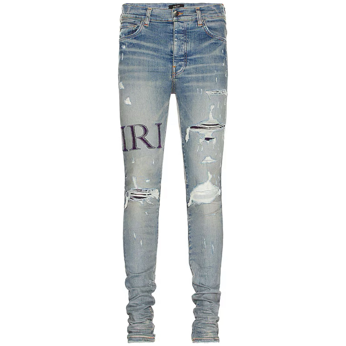 AMIRI light blue distressed jeans with a large purple serif "AMIRI" logo on the left leg, multiple rips, and stacked ankles.