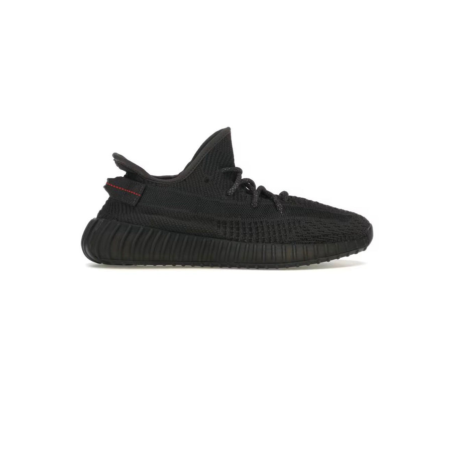 Adidas Yeezy Boost 350 V2 Black Non-Reflective sneaker with Primeknit upper, ribbed sole, and red heel tab stitching.