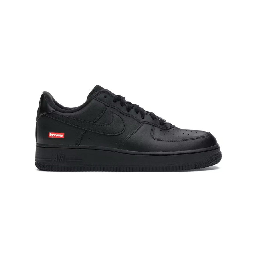 All-black Nike Air Force 1 Low sneaker featuring a red Supreme box logo on the outer heel and a black Nike swoosh.
