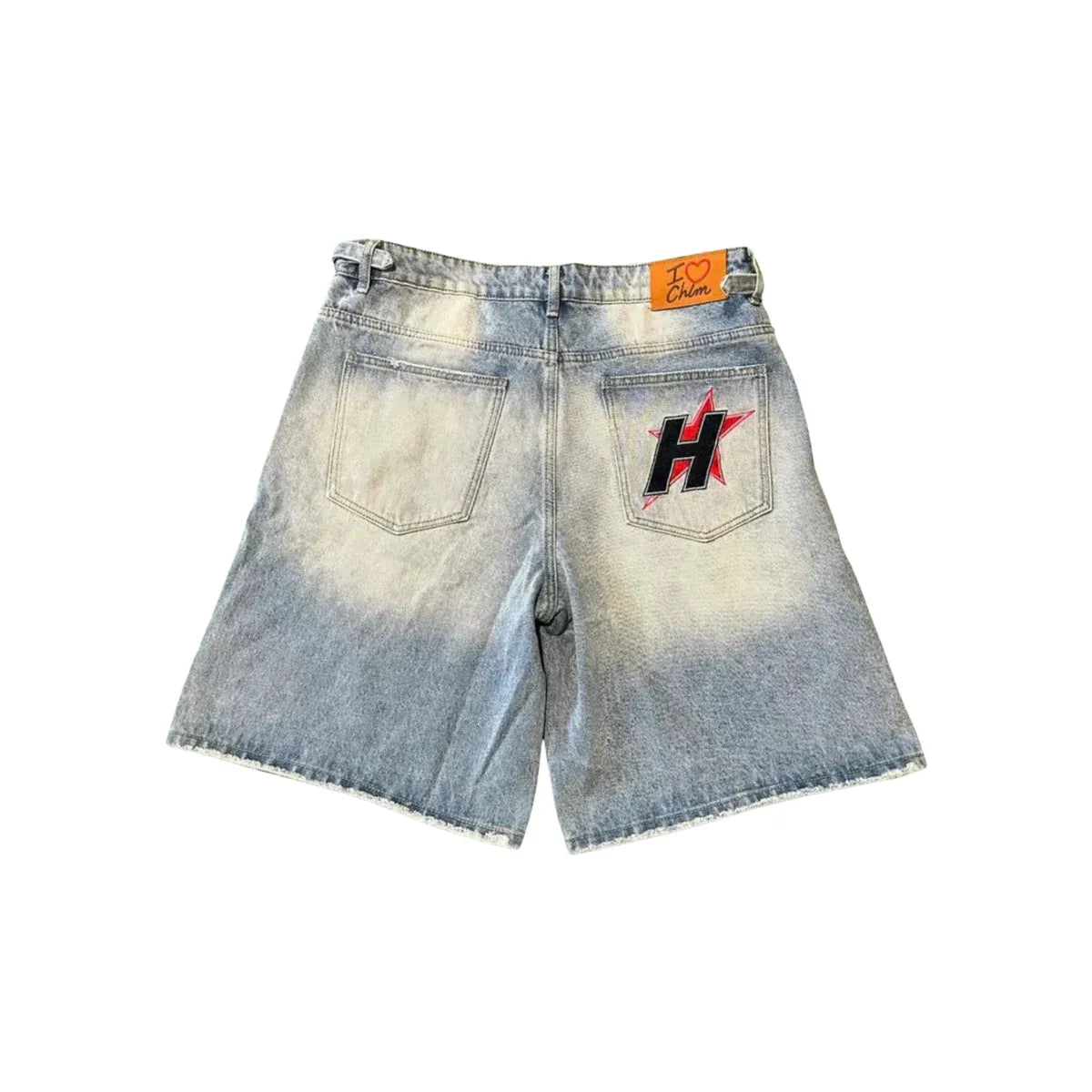 HMDD Crystal lightwash denim jorts, back view. Faded, with a red star and black 'H' on the right pocket. Two back pockets, raw hem.