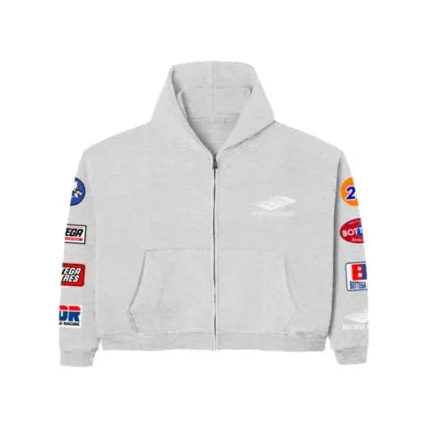 Grey Bottega Desires full-zip hoodie with hood, front pockets, and colorful racing-inspired brand patches on both sleeves.