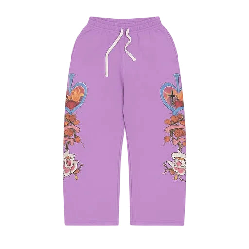 Purple We Are Righteous Risen King sweatpants. White drawstring. Leg graphics: flaming heart, cross, ribbons, roses.