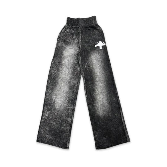 VERTABRAE wide leg washed black sweatpants with elastic waist and white tree-like logo on upper right leg.