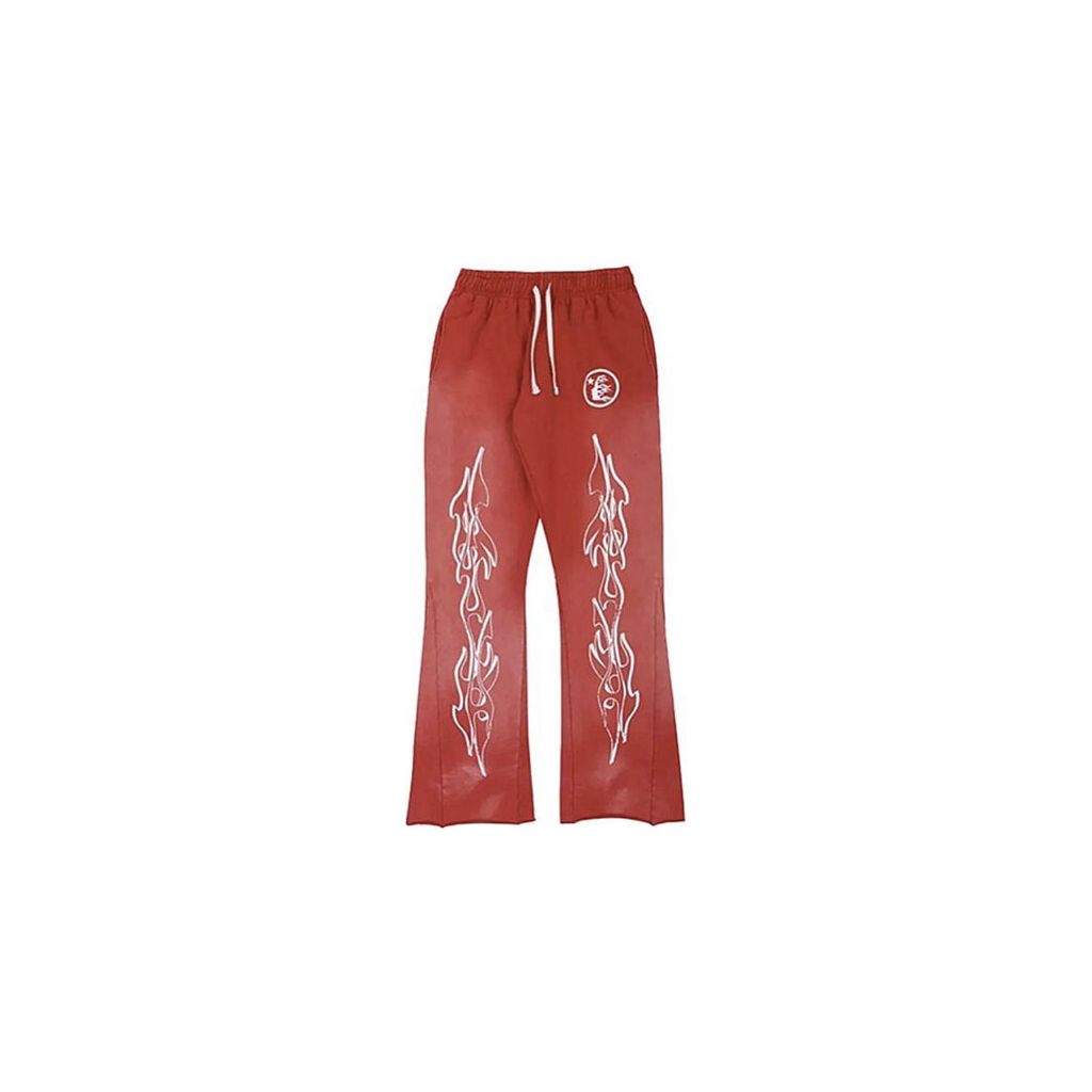 Hellstar Studios red flare sweatpants with white flame graphics on both legs and logo on left thigh.