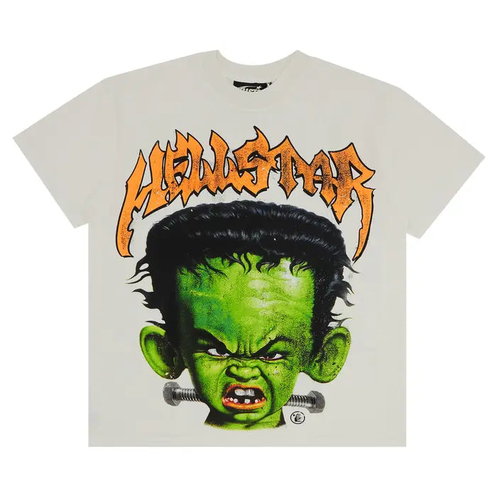Hellstar Studios Frankenkid Tee: Cream shirt with an angry green monster baby head, black hair, neck bolts, & orange Hellstar text.