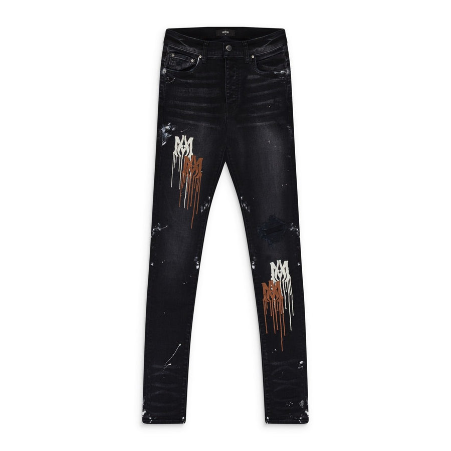 AMIRI MA Drip Aged Black jeans with brown and white dripping "MA" logo, distressed patches, and white paint splatters.