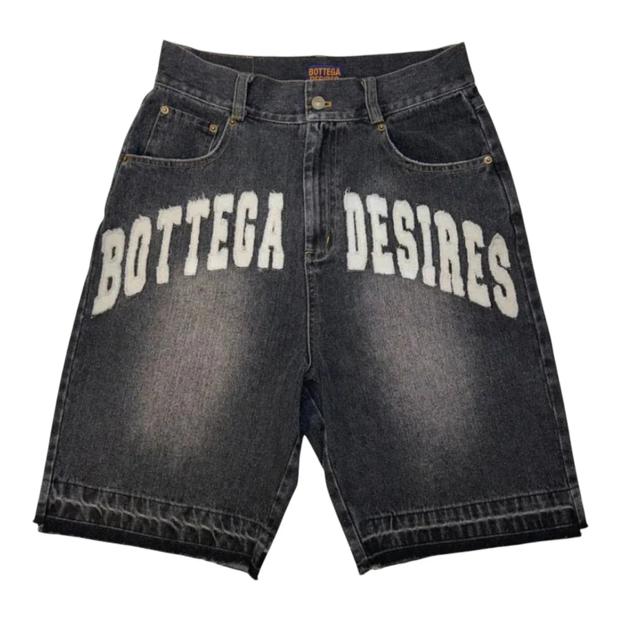 Bottega Desires black wash denim shorts with large white "Bottega Desires" text on the front, relaxed fit & distressed details.