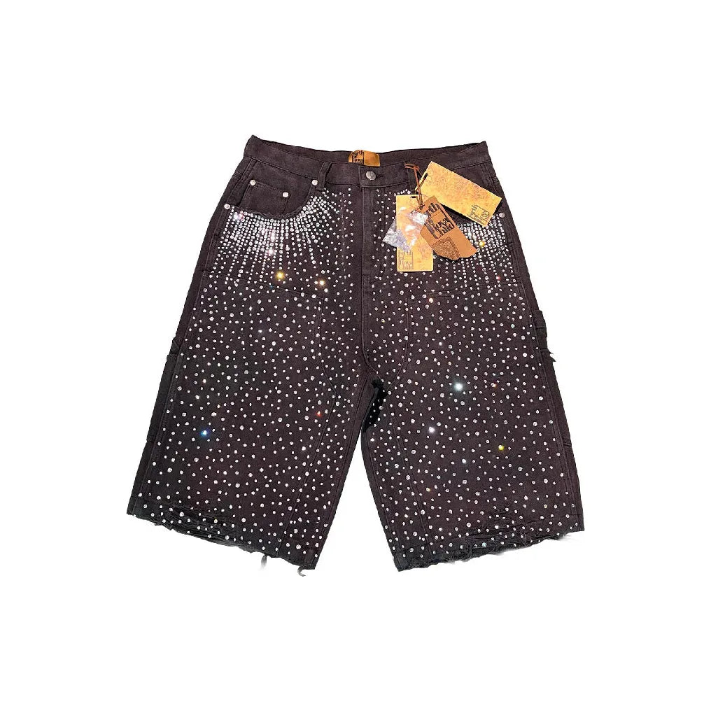 Washed black Redial shorts covered in sparkling 20k diamond studs, concentrated at top & pockets, with frayed hems.