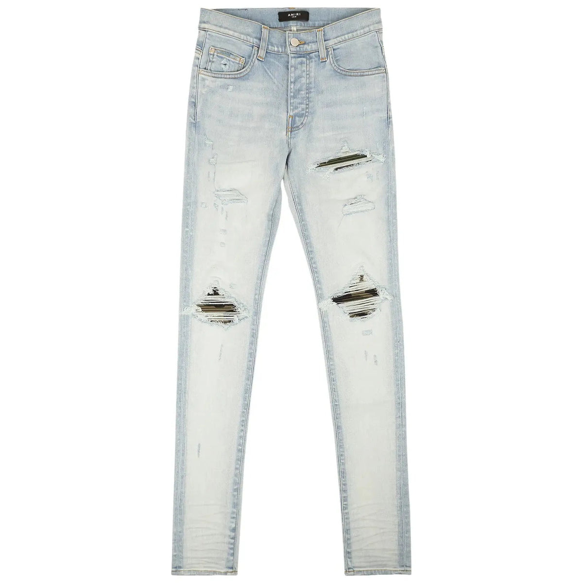 AMIRI MX1 Light Indigo Camo Jean. Distressed skinny denim with green/brown camouflage fabric peeking through large rips at the knees.