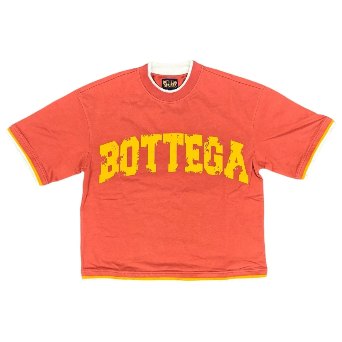 Red Bottega Desires War Tee with distressed yellow 'BOTTEGA' print. White & yellow layered trim on collar, sleeve cuffs, and hem.