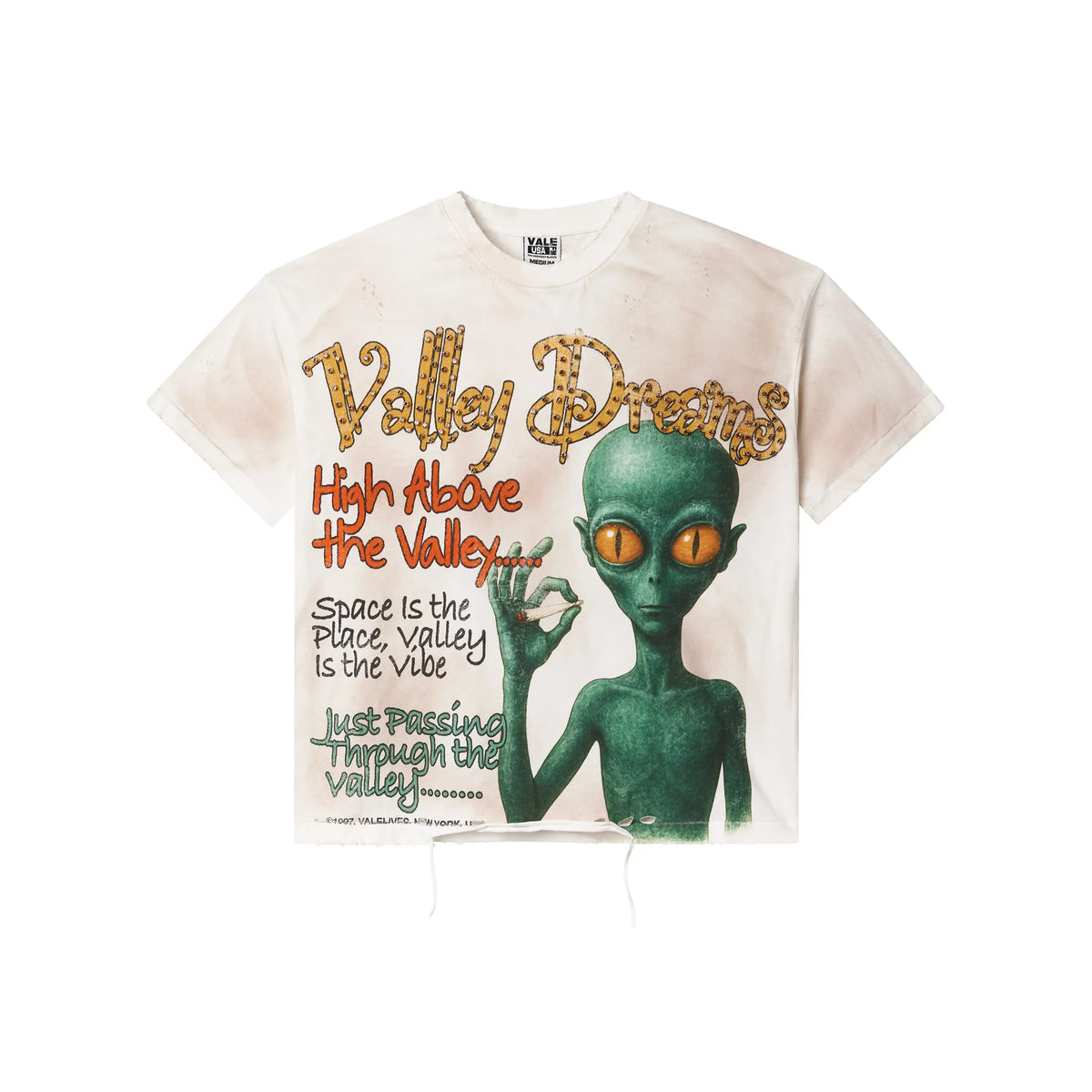 Vale Forever vintage white tee with distressed marks. Features 'Valley Dreams' bling text & green alien with orange eyes holding a joint.