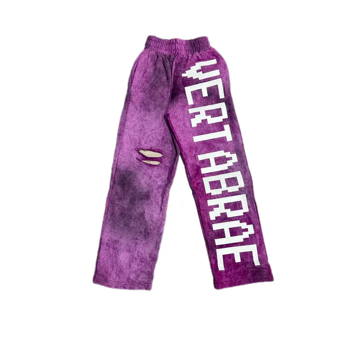 Purple acid-wash sweatpants with a pixelated white 'VERTABRAE' logo on the right leg and two horizontal rips on the left thigh.