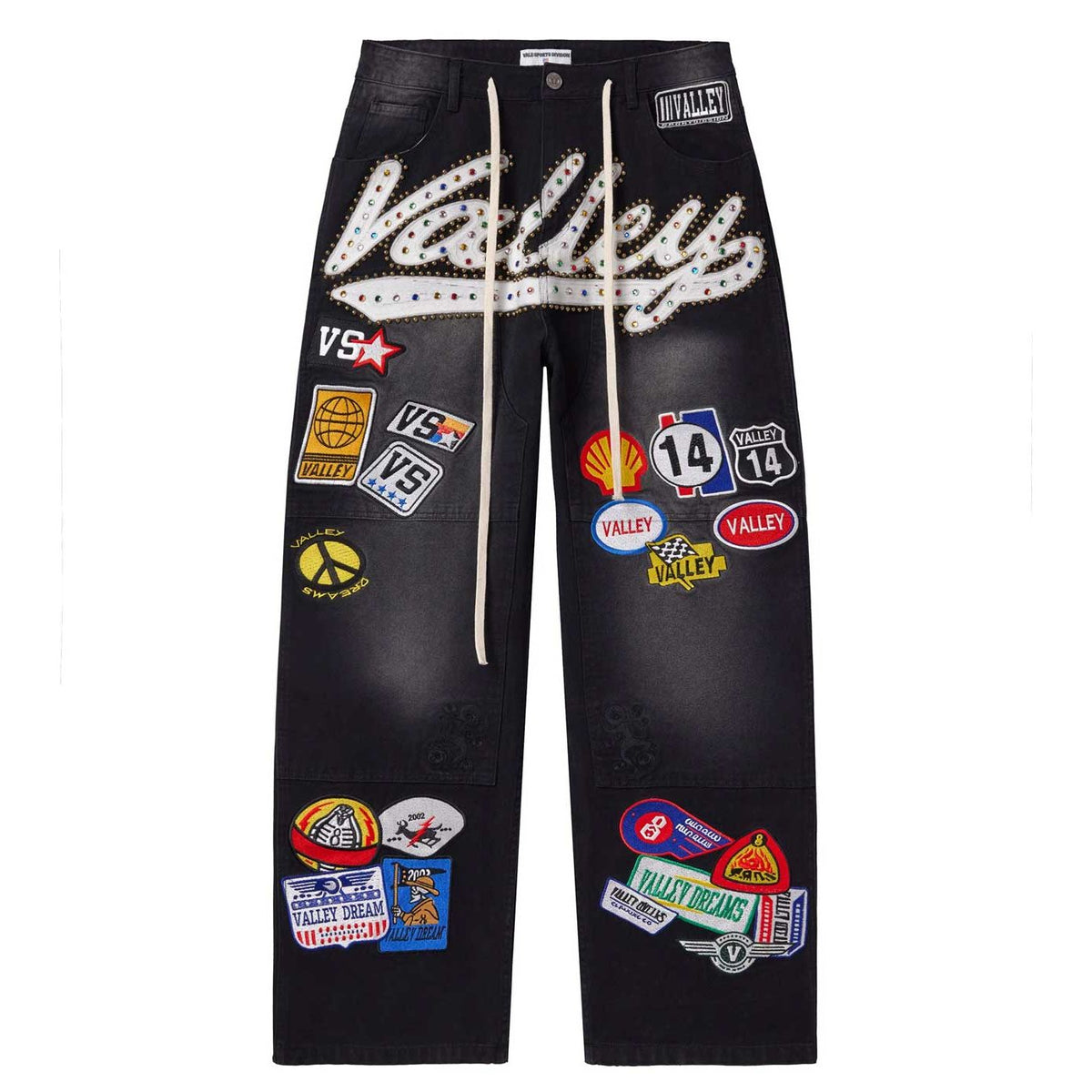 Vale Forever" 1980 black painter denim jeans. Features large white rhinestone "Valley" lettering & many colorful racing patches.