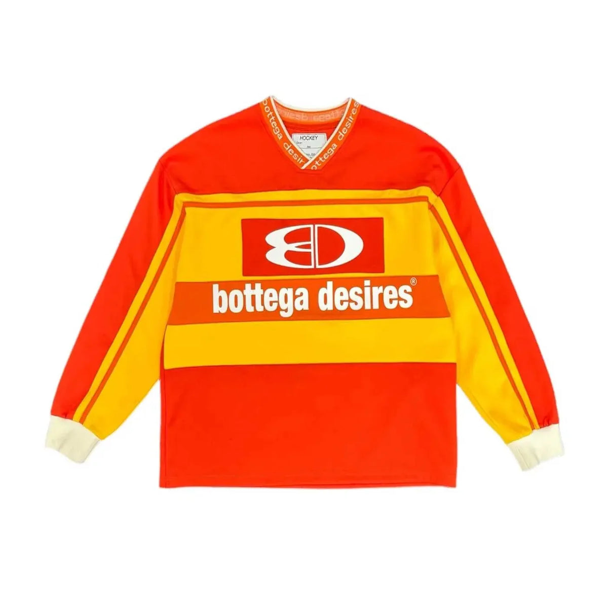 Orange-red Bottega Desires hockey jersey with yellow chest stripe, white "BD" logo & text. Yellow striped sleeves, white cuffs, "bottega desires" v-neck.