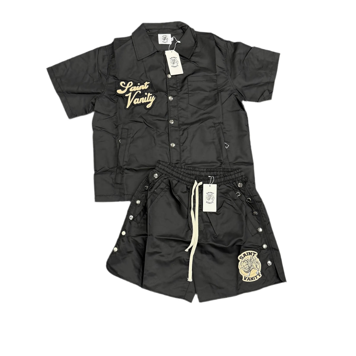 Black Saint Vanity nylon set: short-sleeve collared shirt with gold embroidered logo, matching shorts with side snaps & logo patch.