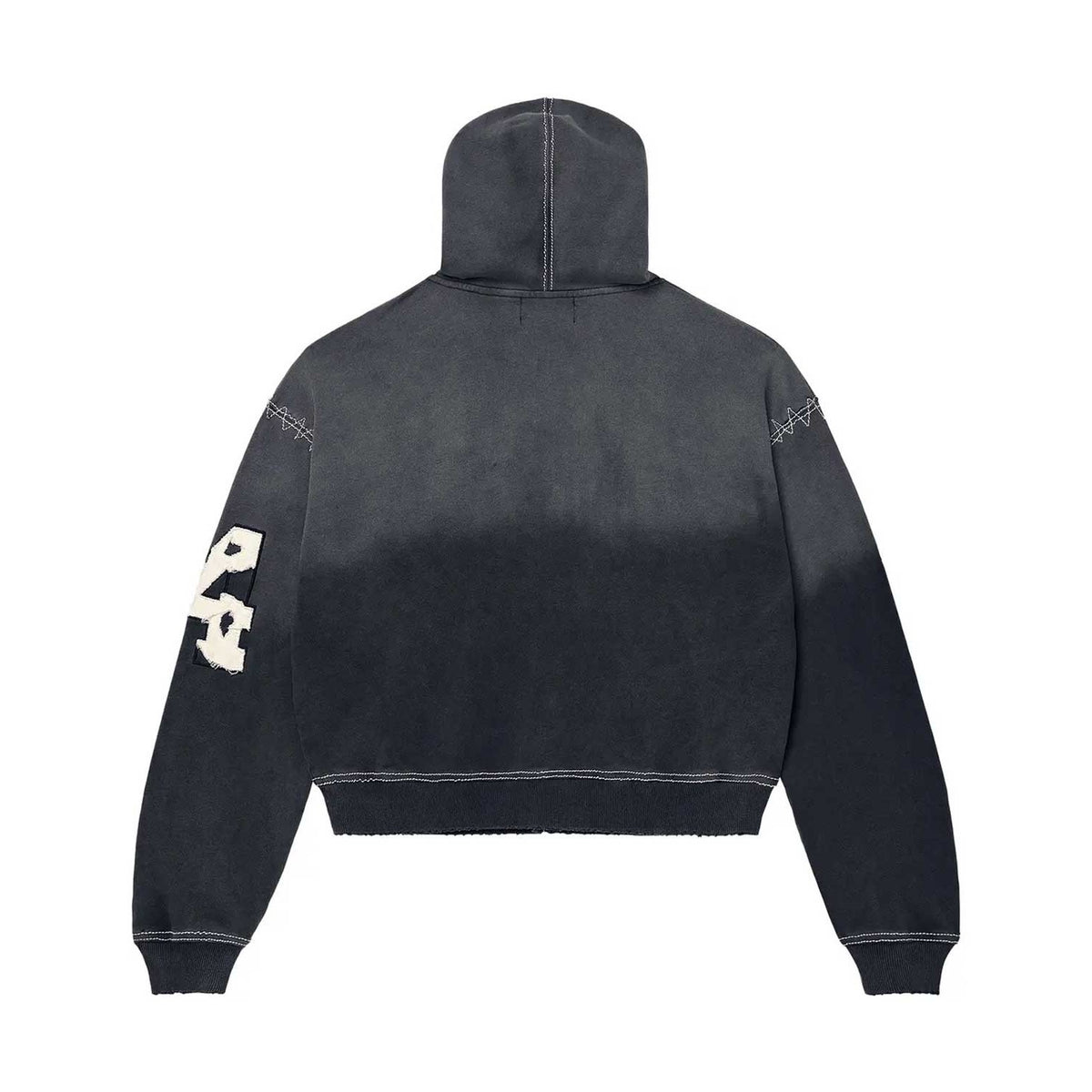 Black Religion zip-up hoodie, back view. Faded wash, white zigzag stitching, "RELIGION" patch on left sleeve, raw hem.