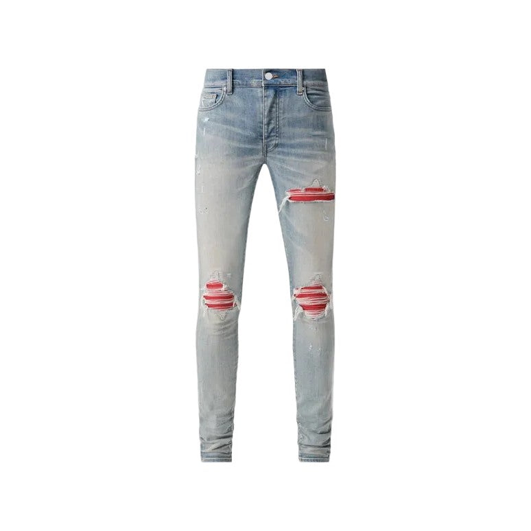 AMIRI MX1 distressed antique indigo skinny jeans with red pleated patches under rips on thighs & knees, stacked ankles.